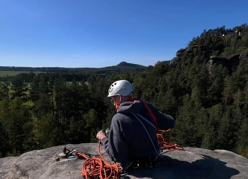 Kletterer auf einem Gipfel im Elbsandsteingebirge  bei gutem Wetter, mit rotem Seil in der Hand. | © Max Lübbers
